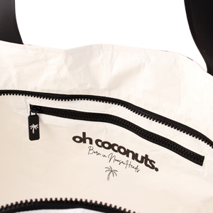White bag with black zipper and 'oh coconuts' branding on a white background