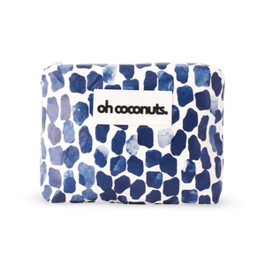 Blue and white patterned clutch with 'oh coconuts.' branding on a white background
