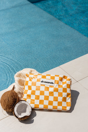 oh coconut beach pouch with water and pool essentials with coconuts. 
