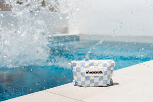 Water splashing in pool repelling off water resistant beach pouch