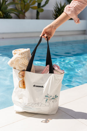 the everything tote holding multiple towels and with water resistant material