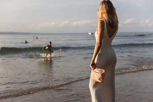 Medium pink palms beach pouch at beach with oh coconuts label