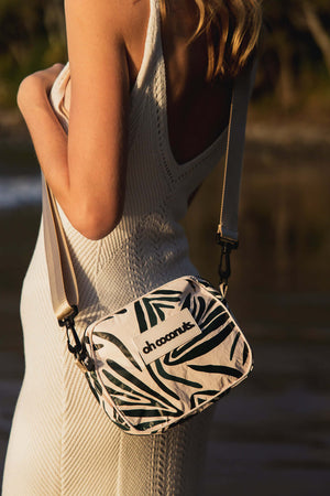 crossbody bag with beige strap with zip pockets and water reistant material